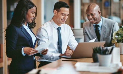 employees and workers in a bright work space with clipboards and friendly smiles