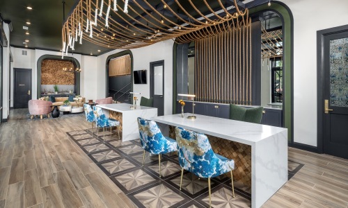 Resident lounge area with wood floors and barstools