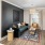 Model living room at our apartments in Peachtree Corners, GA, featuring wood grain floor paneling and windows with curtains.
